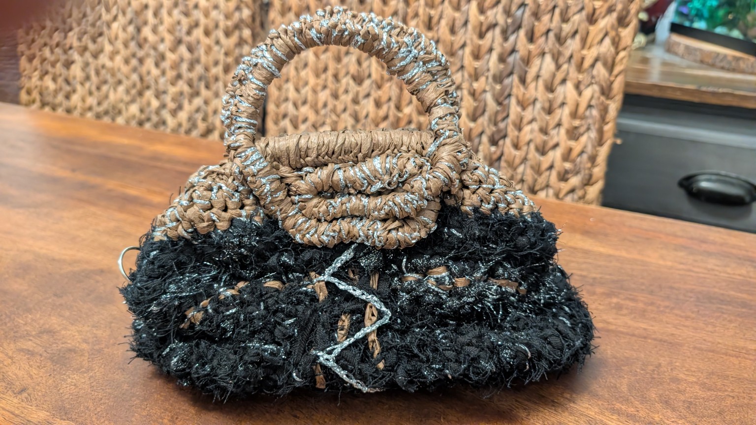 Front view of the completed black, brown and silver textured handbag