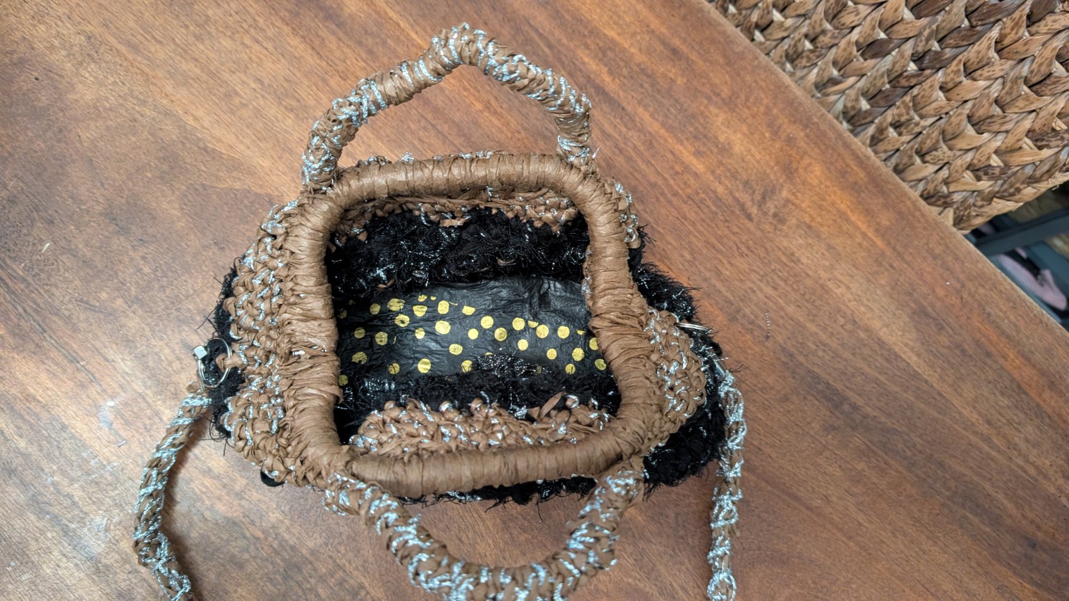 View inside the handbag showing the structured fused-plastic-covered base
