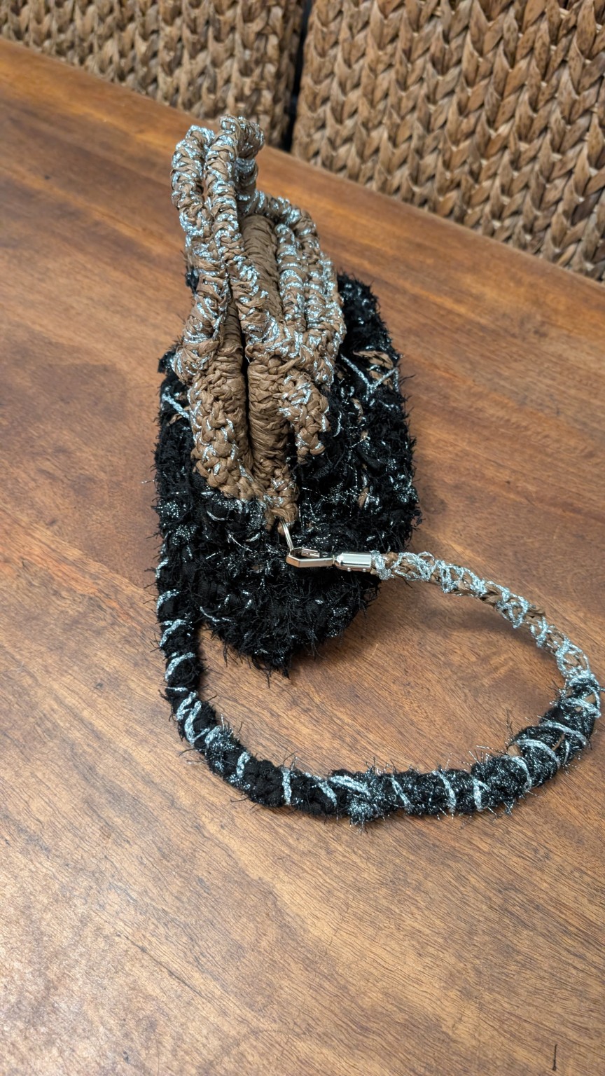 Side view of the completed handbag with its removable shoulder strap