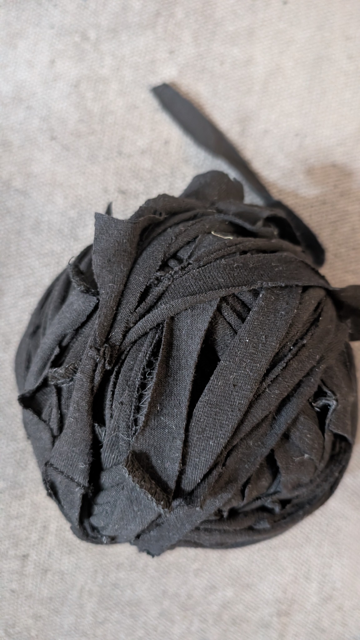 Reclaimed black textile strips prepared for the Gilded Tide bag